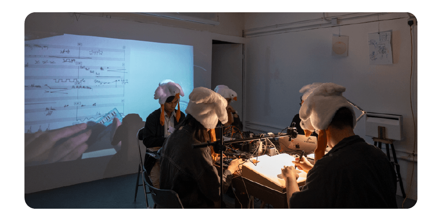 image of 5 people playing in front of a screen drawing scale
